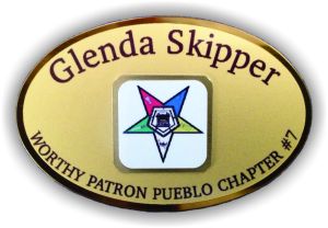 This enhanced gold metal oval name badge features a layered multi-level design with an elevated metal layer with logo!