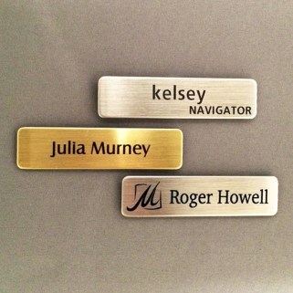 brass and silver name tags
